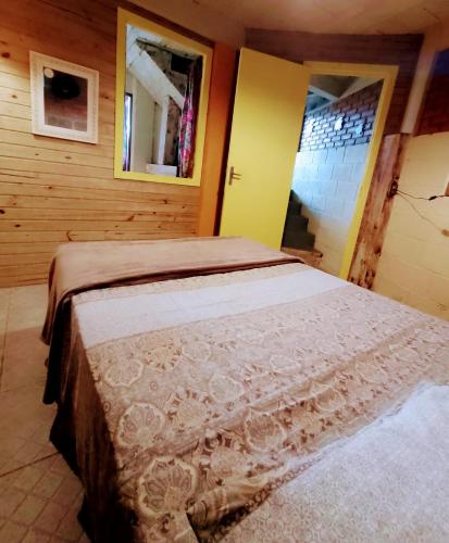 a bedroom with a large bed in a room at Hostel Aroeira do campo in Florianópolis