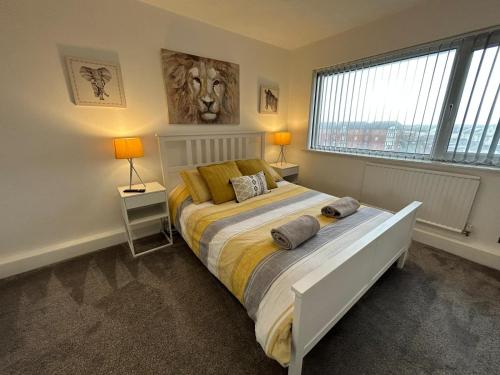a bedroom with a bed and a large window at Seaview House in Cleveleys