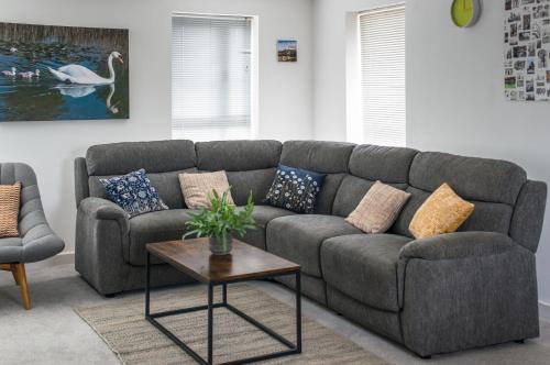 a living room with a gray couch and a table at Cambridge Orchard Apartments - 2 double bedrooms in Cambridge