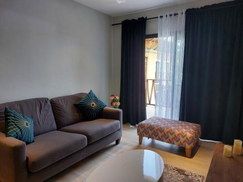 a living room with a couch and a table at Forest View Apartments in Kololi