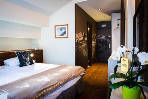 Postel nebo postele na pokoji v ubytování Hotel De Champoluc