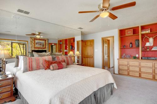 a bedroom with a bed and a ceiling fan at Spicewood Treehouse in Spicewood