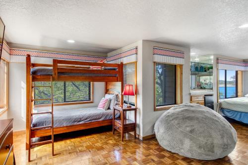 a bedroom with two bunk beds and a large bed at Spicewood Treehouse in Spicewood