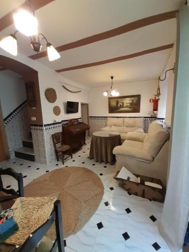 a living room with a couch and a table at Casa Rincón in Iznatoraf