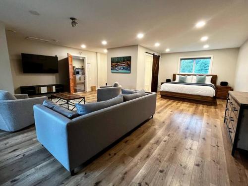 a large living room with a couch and a bed at Two Bedroom House by Snow Valley Lodging in Fernie
