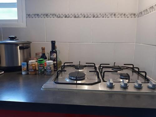 a stove top oven sitting on top of a kitchen counter at Pomme de Pin in Cilaos