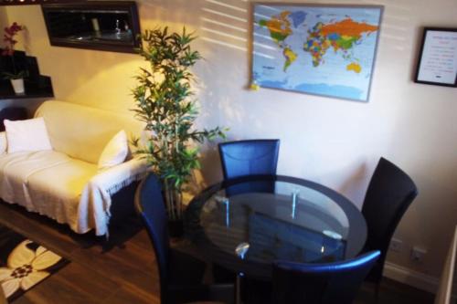 a living room with a table and a couch and a table and a glass table at Must see, Quality 1 bed, Romford, 20 mins C.London in Romford