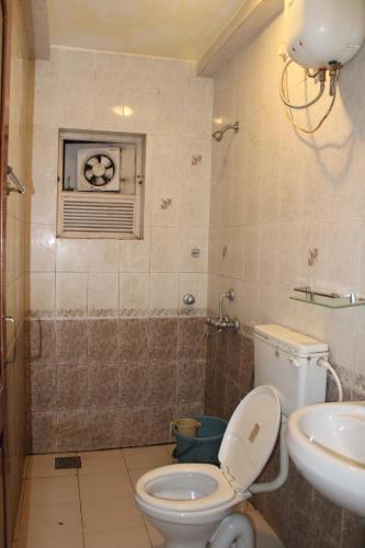 a bathroom with a toilet and a sink at 2Bhk Apartments in Old Goa