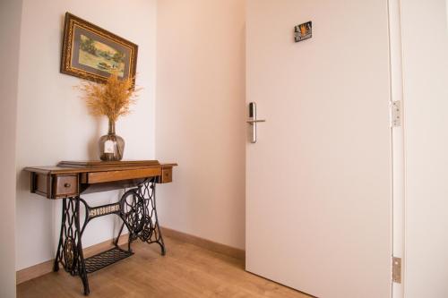a room with a door and a table with a vase on it at 188 Apartments - Estrelícia - pool and balcony in Cascais