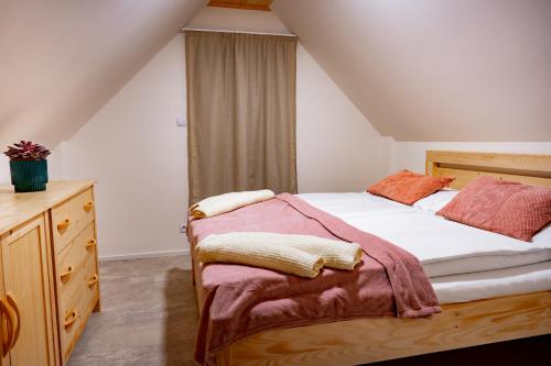 a bedroom with a bed and a dresser at Apartmány NONE in Branná