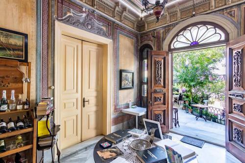 a room with a door and a table with books at Büyükada Anastasia Meziki History Mansion in Buyukada