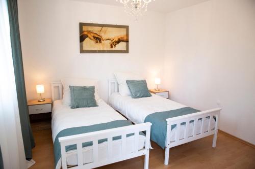 two twin beds in a room with two lamps at Große Wohnung, 100 qm mit Terrasse in Alzenau in Unterfranken