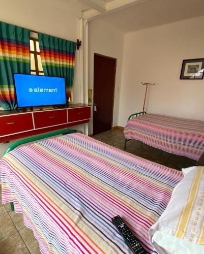 Ein Bett oder Betten in einem Zimmer der Unterkunft Hostal Mixteco Naba Nandoo