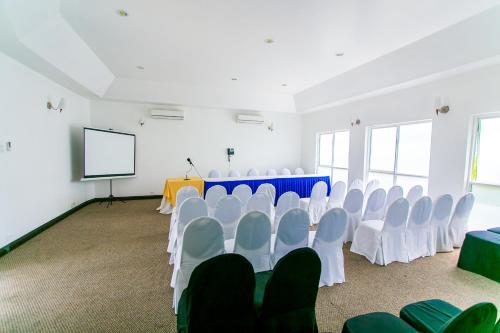 a conference room with white chairs and a screen at Altamont Court Hotel in Kingston