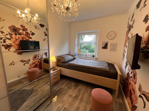 a bedroom with a bed and a mirror at Unterwegs an der Nordsee in Wilhelmshaven