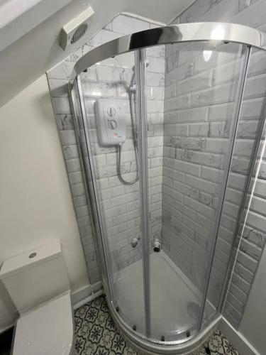 a shower with a glass door in a bathroom at Porchester House Nottingham in Nottingham