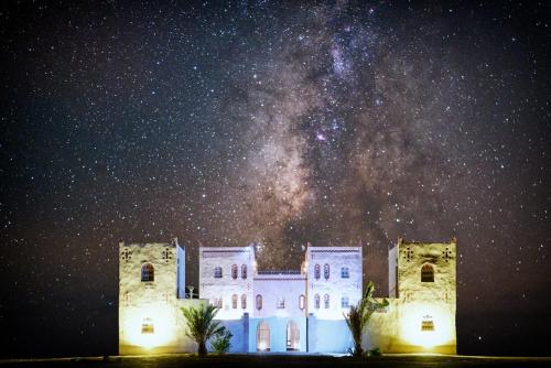 a building with the milky way in the sky at Dar Morocco in Merzouga