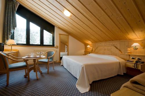 Кровать или кровати в номере Chalet Al Lago