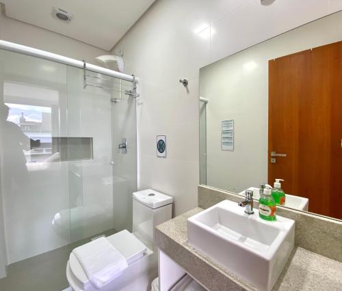 a bathroom with a sink and a toilet and a shower at Dona Floripa in Florianópolis