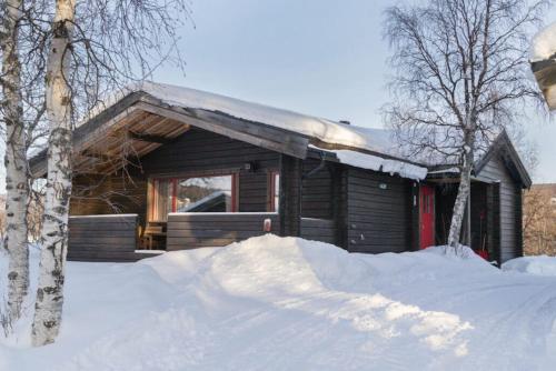 a log cabin with snow in front of it at Lullens Stugby - Stugorna 1-5 in Bruksvallarna
