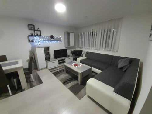 a living room with a couch and a table at Apartman LELA in Karlovac