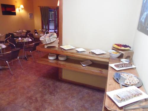 a room with a table with plates of food on it at Hotel Departamentos del Sur in Puerto Montt