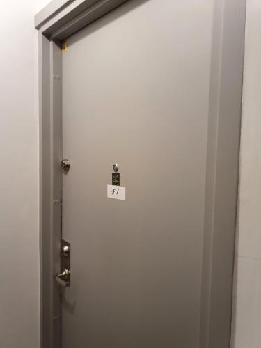 a door with a sign on it in a bathroom at Zöld Relax Apartments in Budakeszi