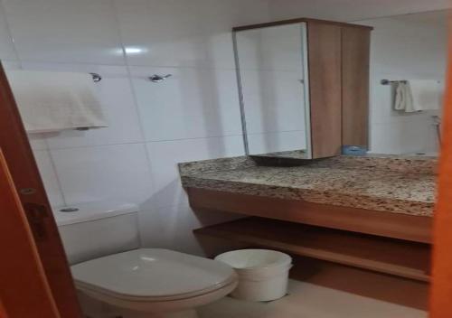 a bathroom with a toilet and a sink and a mirror at Quality Hotel & Suites Brasília in Brasília
