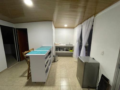a small kitchen with a counter and a refrigerator at Cabañas Avani in San Francisco