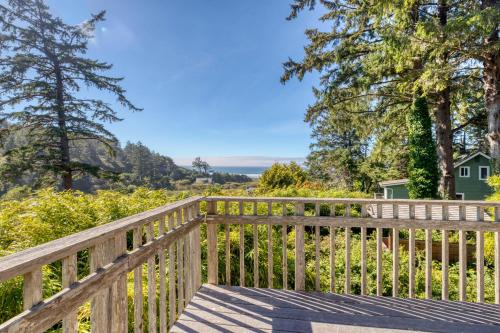 a wooden deck with a view of the ocean at Bamboo House - Meredith Lodging in Nehalem