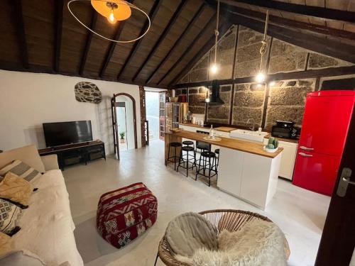 a kitchen and living room with a red refrigerator at Vistas impresionantes al mar de Garachico in Garachico