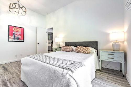 a white bedroom with a bed and a nightstand at Modern Escape with Fire Pit, Near Lake Waramaug in Kent