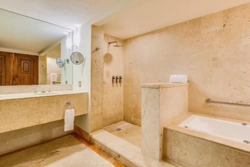 a bathroom with a tub and a sink at Grand Fiesta Americana Los Cabos All Inclusive Golf & Spa in Cabo San Lucas