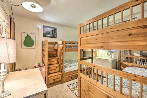 a bedroom with two bunk beds and a desk at Colorful Pocono Lake Cabin with Deck and Fire Pit in Pocono Lake