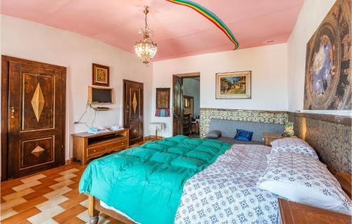 a bedroom with a large bed with a green comforter at Castello Dei Diamanti in Belvedere Langhe