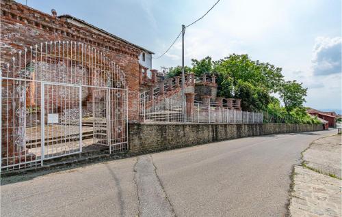 a brick wall with a gate on the side of a street at Castello Dei Diamanti in Belvedere Langhe