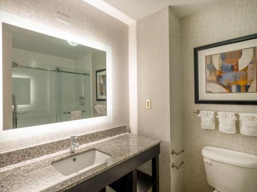 a bathroom with a sink and a toilet and a mirror at Holiday Inn Express Gas City by IHG in Gas City