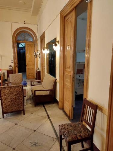 a living room with a couch and a chair at Clement's House Hostel in Alexandria