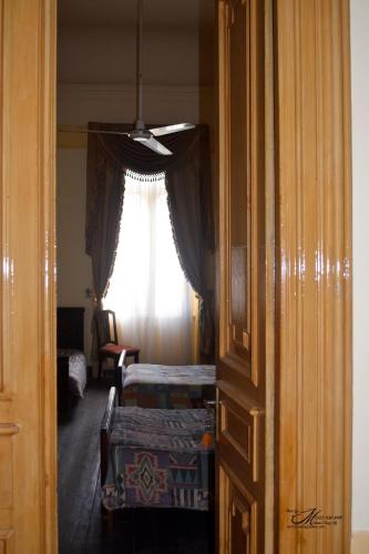 a room with a window and a room with two beds at Clement's House Hostel in Alexandria