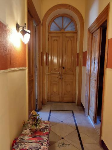 a hallway with a wooden door in a room at Clement's House Hostel in Alexandria