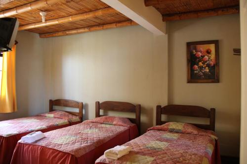 A bed or beds in a room at Hostal Tambo Colorado