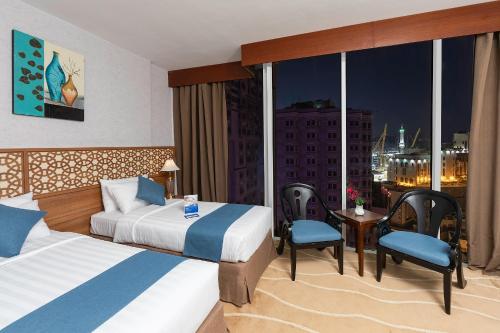 Postel nebo postele na pokoji v ubytování Sunrise Ajyad Hotel