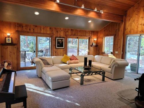 a living room with a couch and a coffee table at CASA de los ARBOLES! Delight & Solitude Abound! in Pine Cove