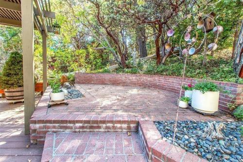 a brick patio with potted plants on it at CASA de los ARBOLES! Delight & Solitude Abound! in Pine Cove