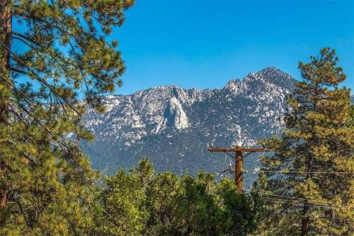 a mountain in the distance with a telephone pole and trees at CASA de los ARBOLES! Delight & Solitude Abound! in Pine Cove