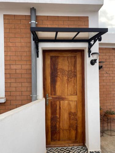 a wooden door on the side of a house at Marciloui in Antsirabe