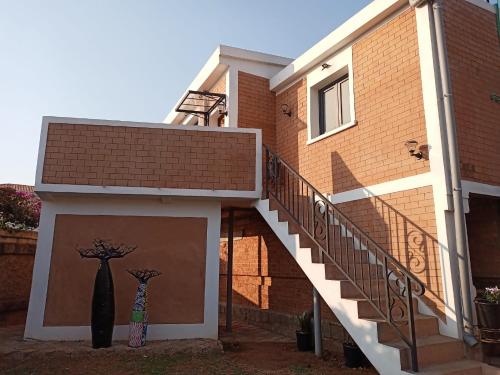 a building with a door with two dresses on it at Marciloui in Antsirabe