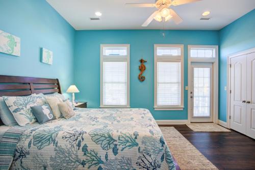 a blue bedroom with a bed and a ceiling fan at Your Turn in Surf City