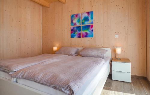 a bedroom with a bed and a painting on the wall at Ferienhaus 4 Wolfsschlucht in Gondenbrett