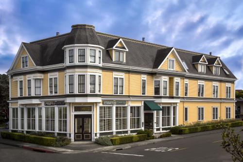 a large yellow building with a black roof at Carter House Inns in Eureka